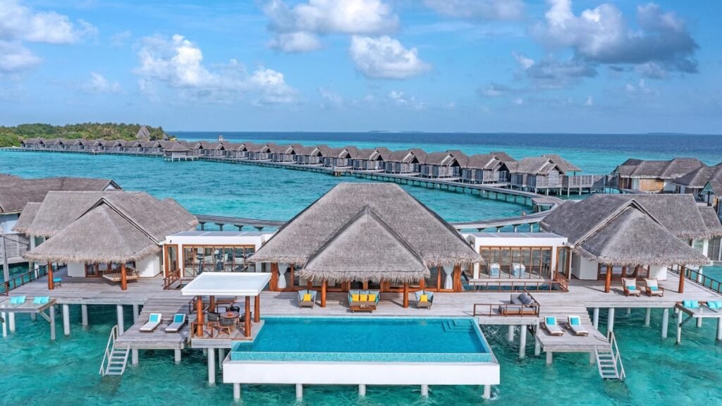 Overwater restaurant and pool at Anantara Kihavah Maldives Villas