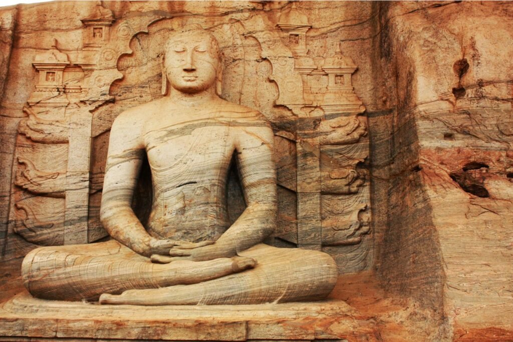 Seated stone Buddha carved into rock at Polonnaruwa