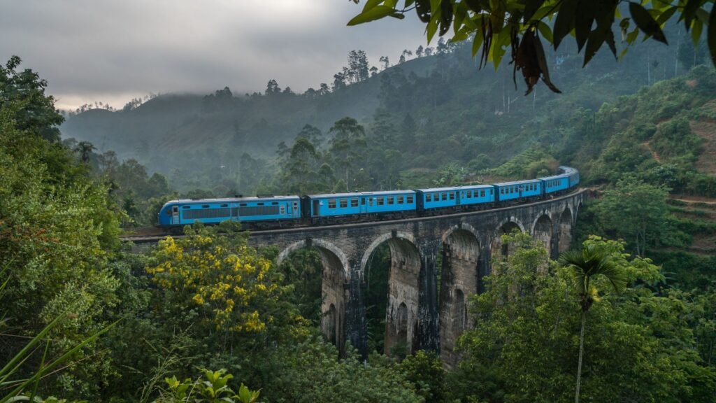 Blue train crossing the Nine Arch Bridge in Ella, Sri Lanka