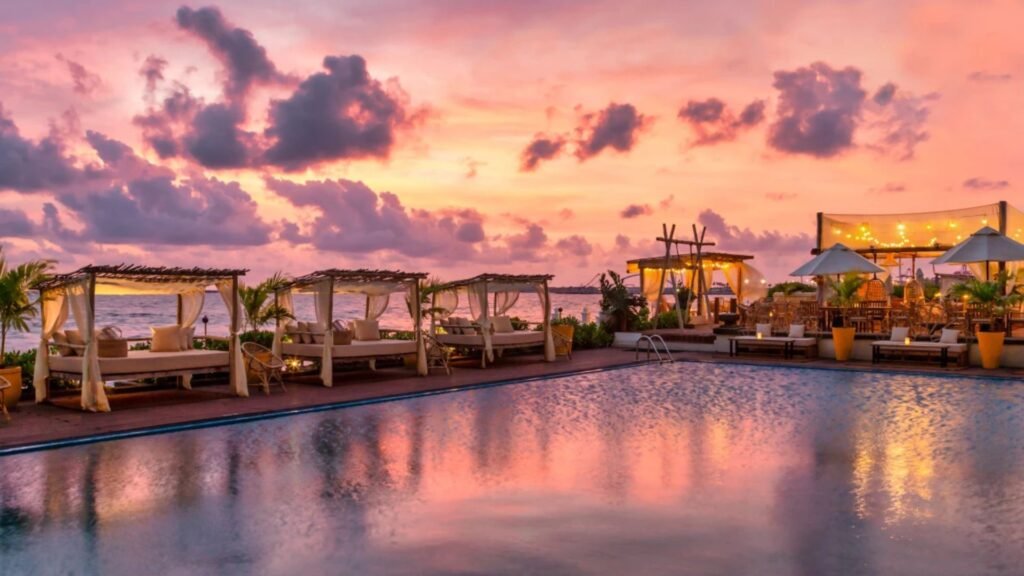 Poolside cabanas at Galle Face Hotel under a pink sunset