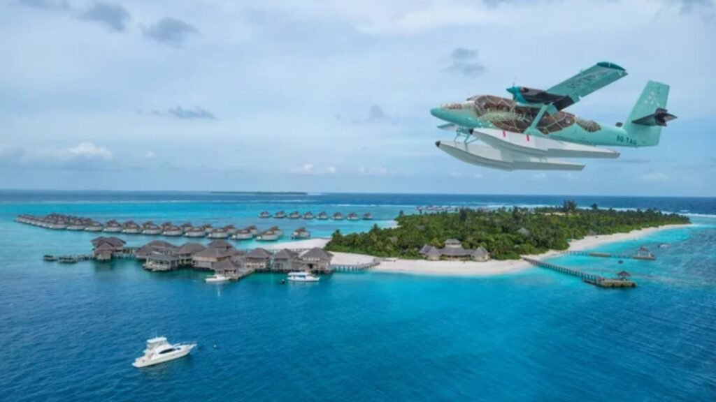 Seaplane flying over the overwater villas at Six Senses Laamu