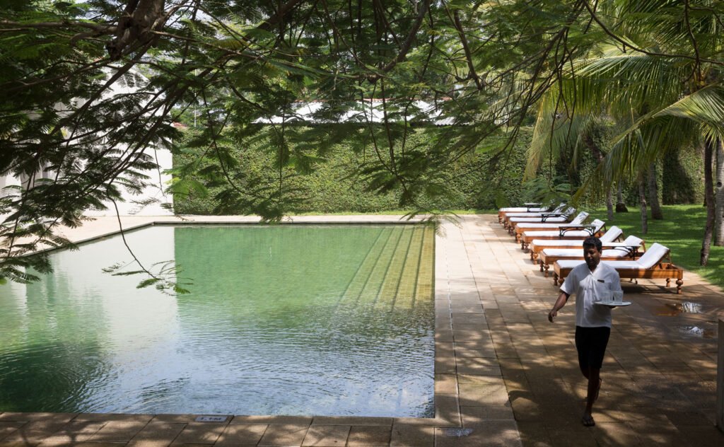 Pool and loungers under the trees at Amangalla, Galle Fort