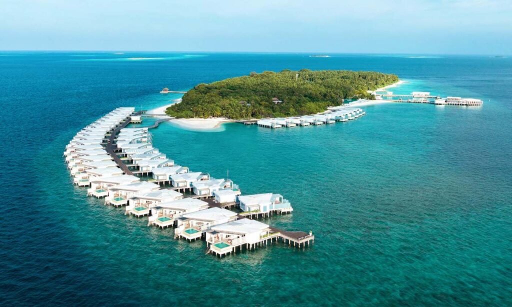 Aerial view of the villas curving around Amilla Maldives