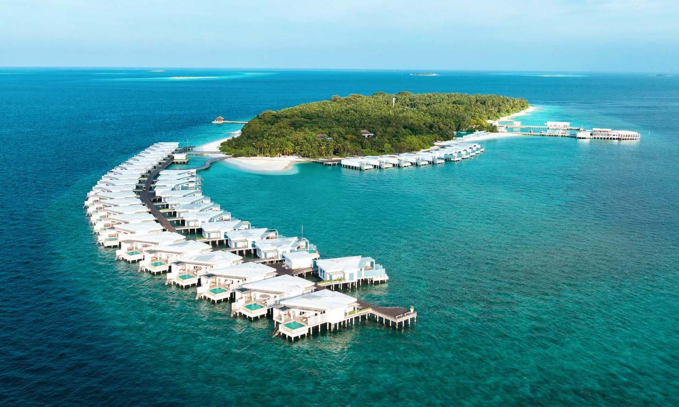 Aerial view of the villas curving around Amilla Maldives
