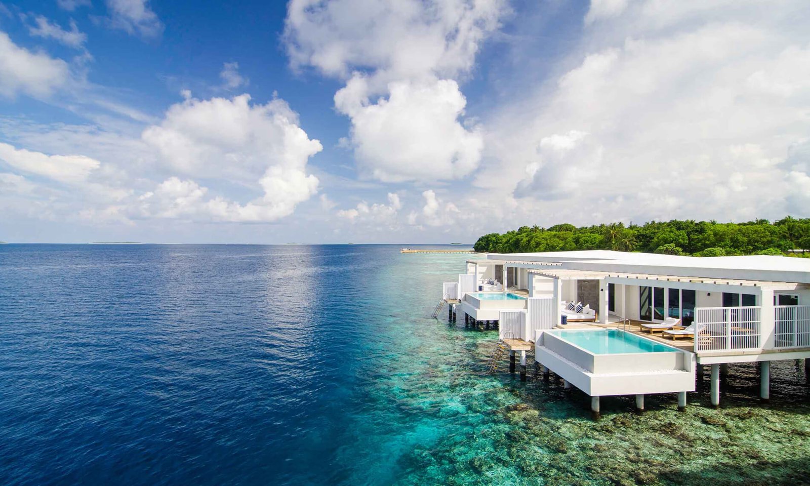 Overwater villa above deep blue water at Amilla Maldives