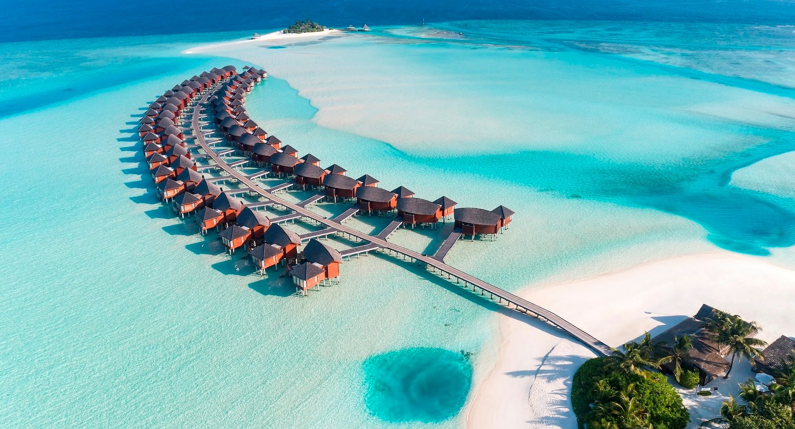 Aerial view of the overwater villas at Anantara Dhigu Maldives Resort