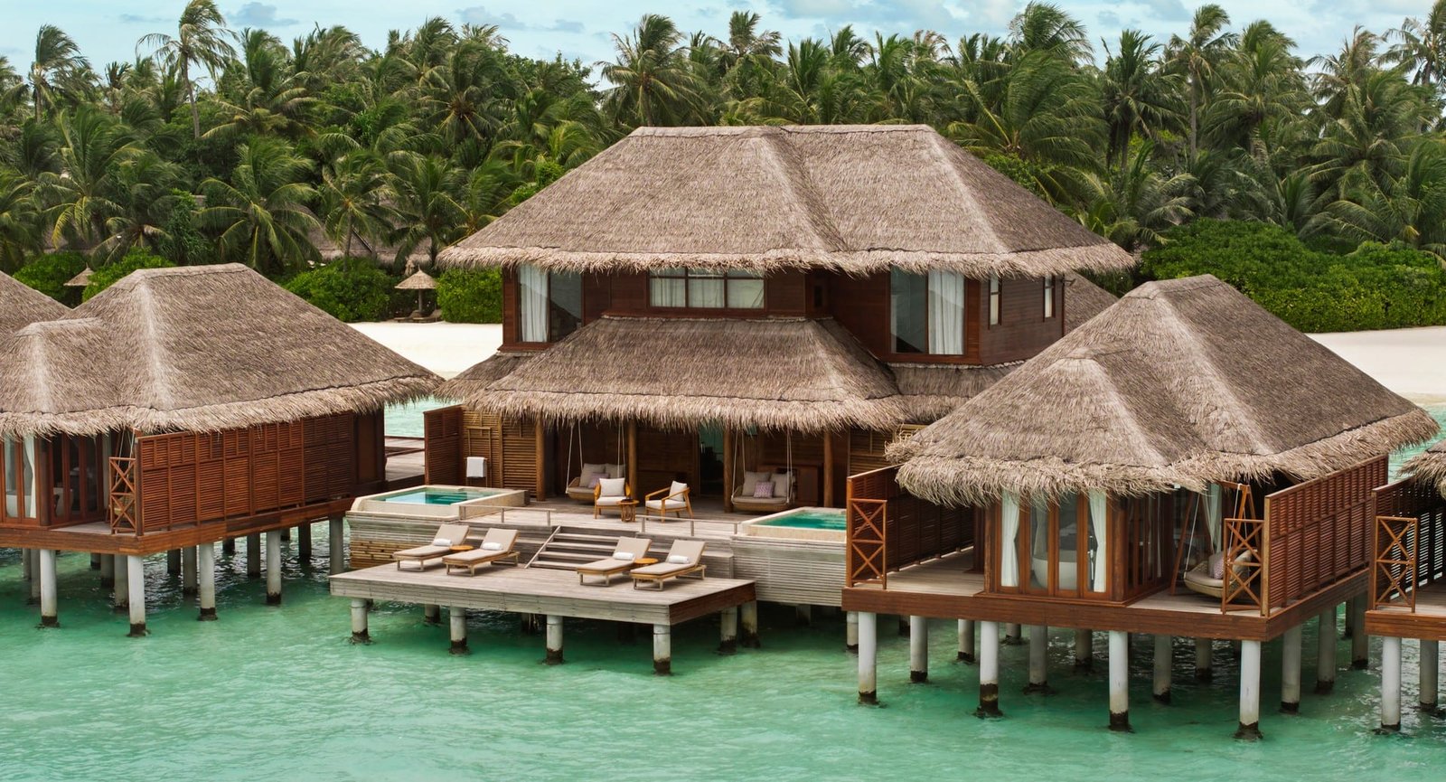 Thatched overwater villa and deck at Anantara Dhigu