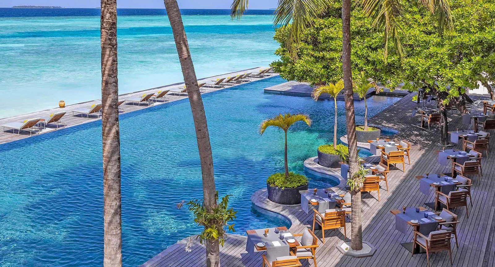 Pool and deck beside the lagoon at Anantara Kihavah