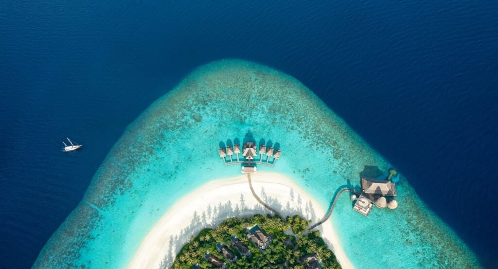 Aerial view of Anantara Kihavah island and its overwater villas
