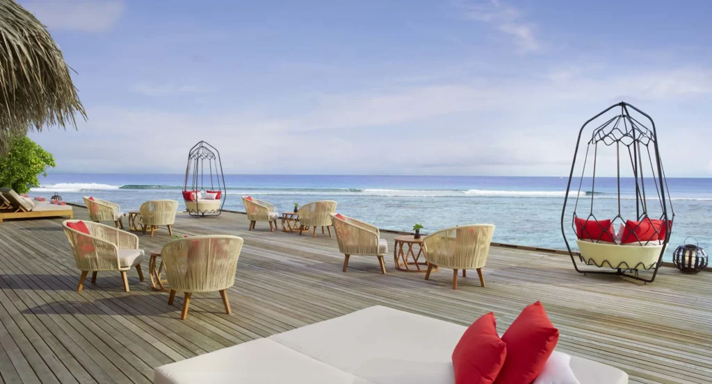 Overwater deck with hanging chairs at Anantara Veli