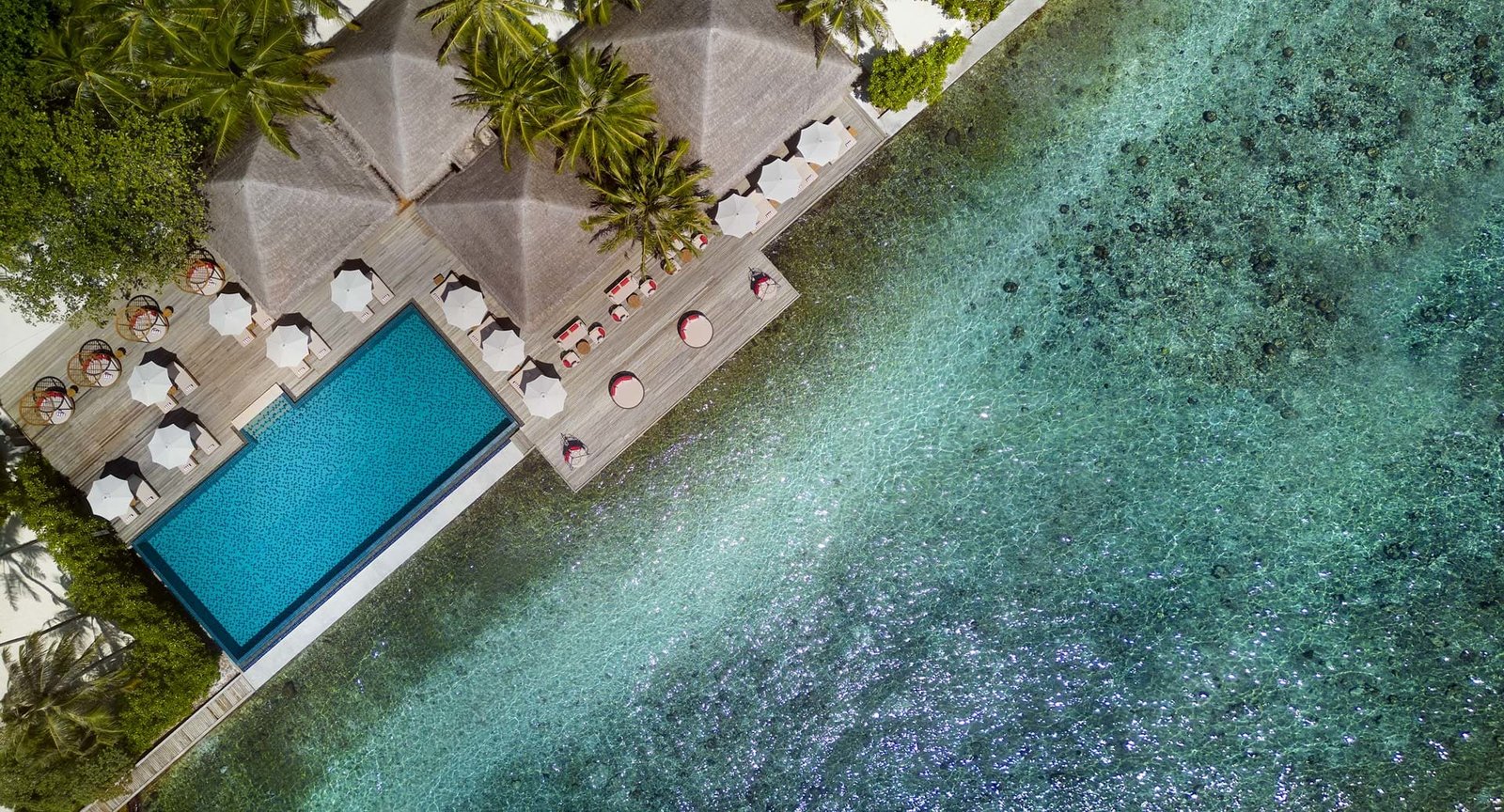 Aerial view of an overwater villa and pool at Anantara Veli