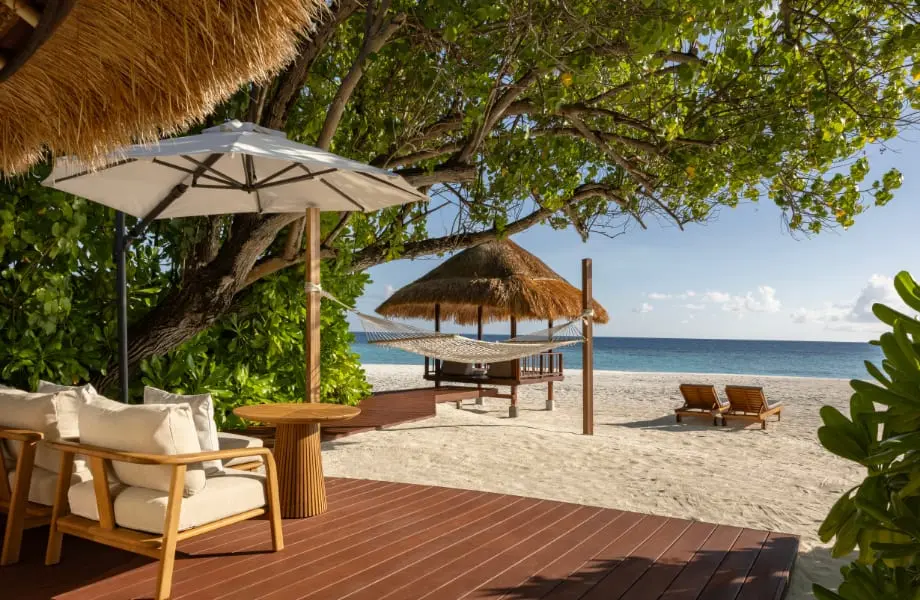 Shaded beach deck with loungers at Banyan Tree Vabbinfaru