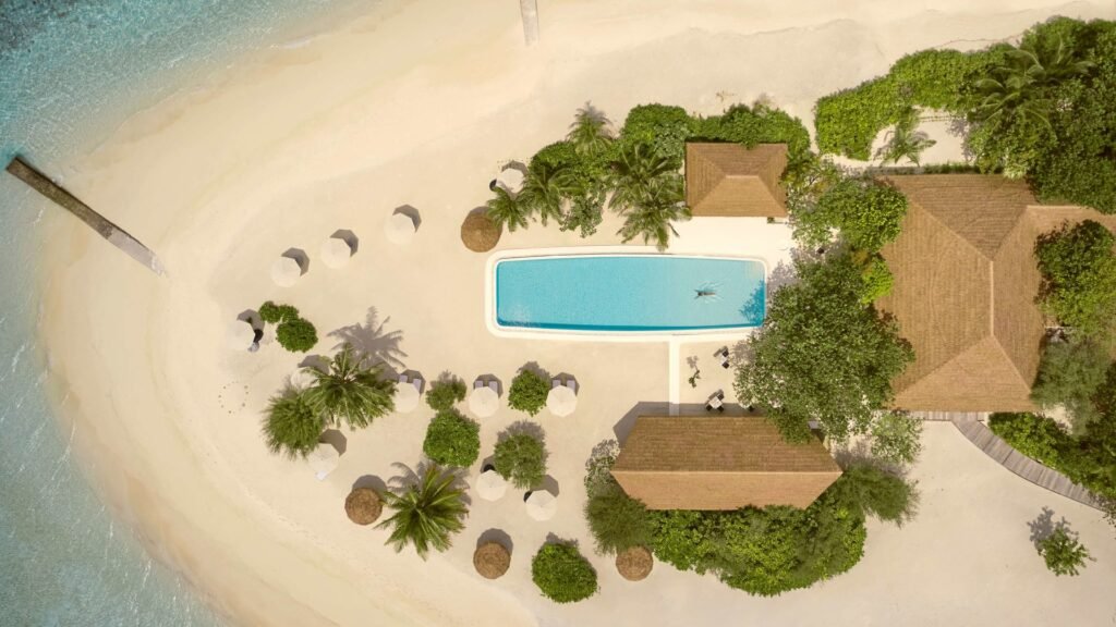 Aerial view of the beach villas and pool at COMO Cocoa Island