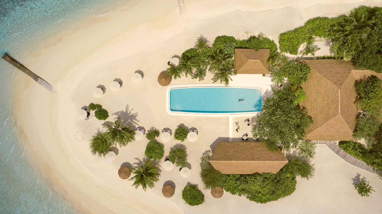 Aerial view of the beach villas and pool at COMO Cocoa Island