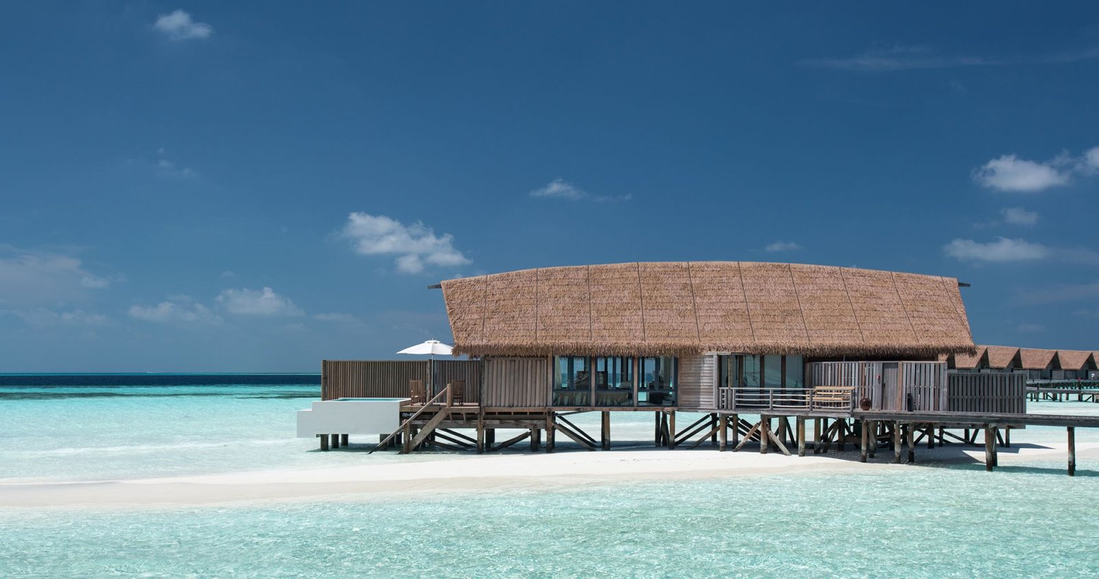 Overwater villa above a white sandbank at COMO Cocoa Island