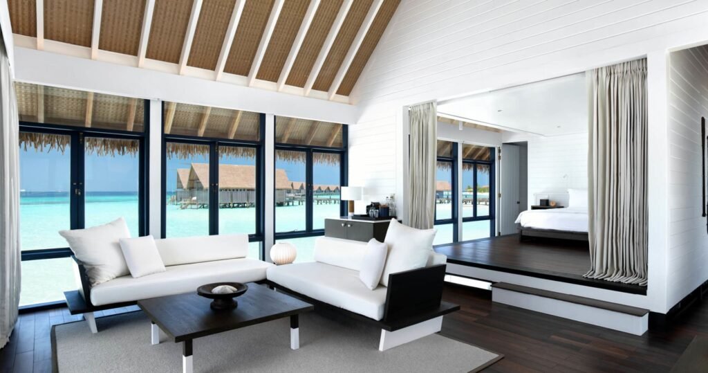 Villa interior with a bed and sea view at COMO Cocoa Island