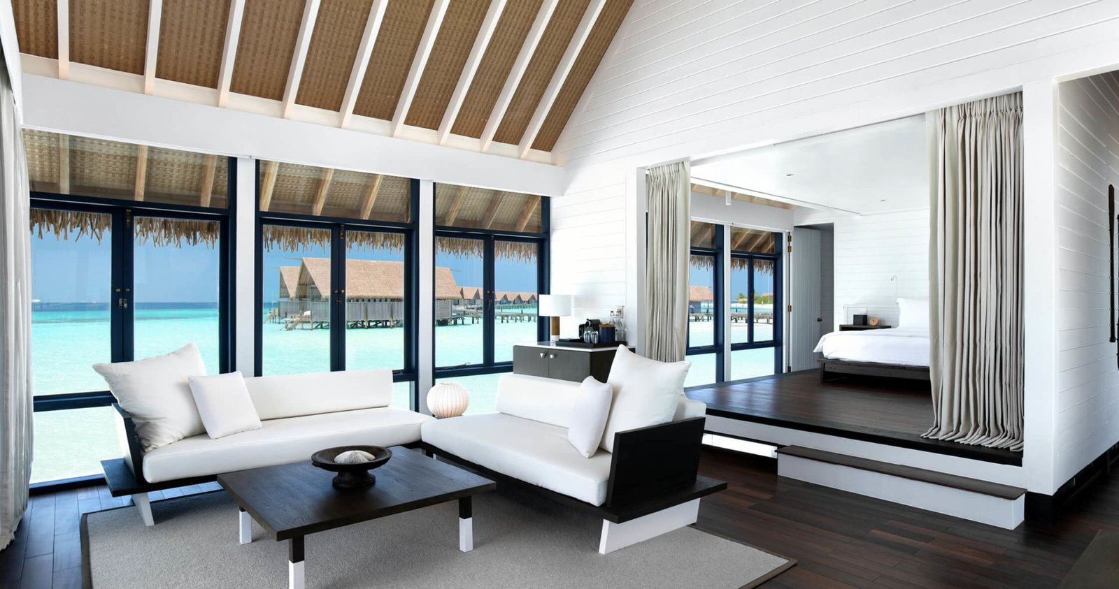 Villa interior with a bed and sea view at COMO Cocoa Island