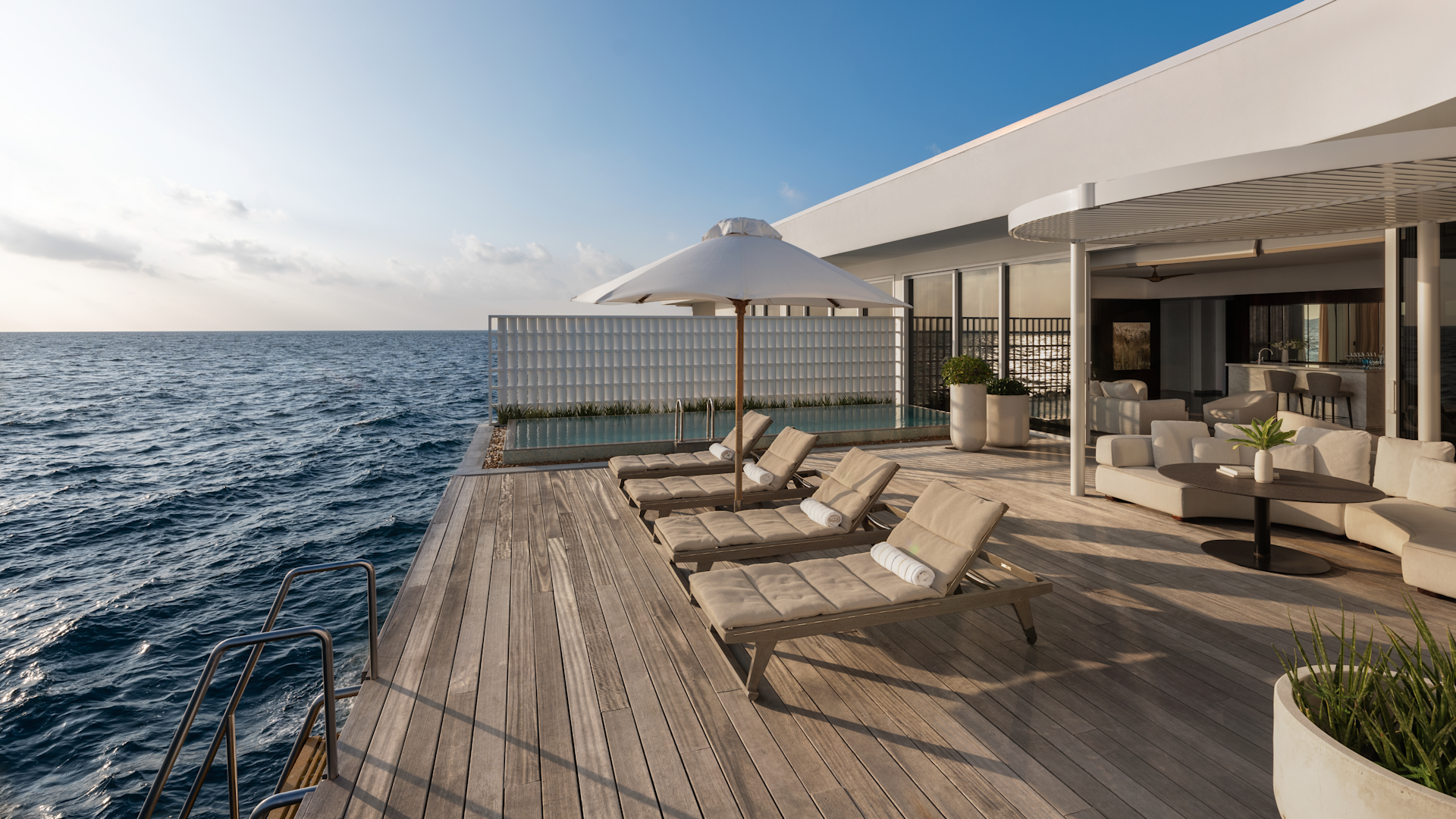 Villa deck and loungers above the sea at Conrad Maldives Rangali Island