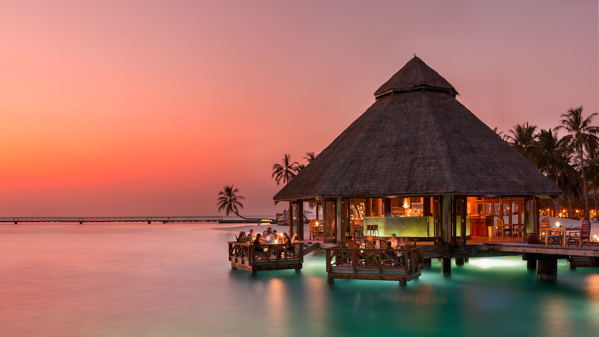Overwater restaurant at sunset at Conrad Maldives Rangali Island