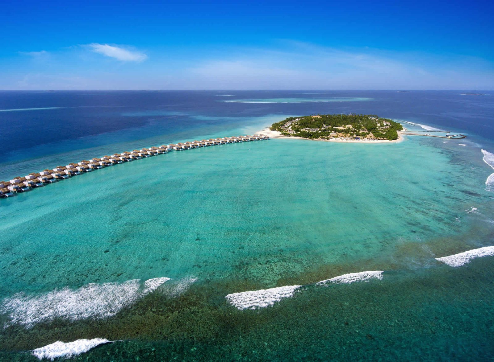Aerial view of Emerald Maldives Resort and Spa island and reef