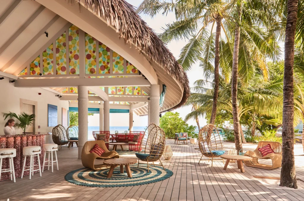 Open-sided lounge with colourful decor at Finolhu, Baa Atoll