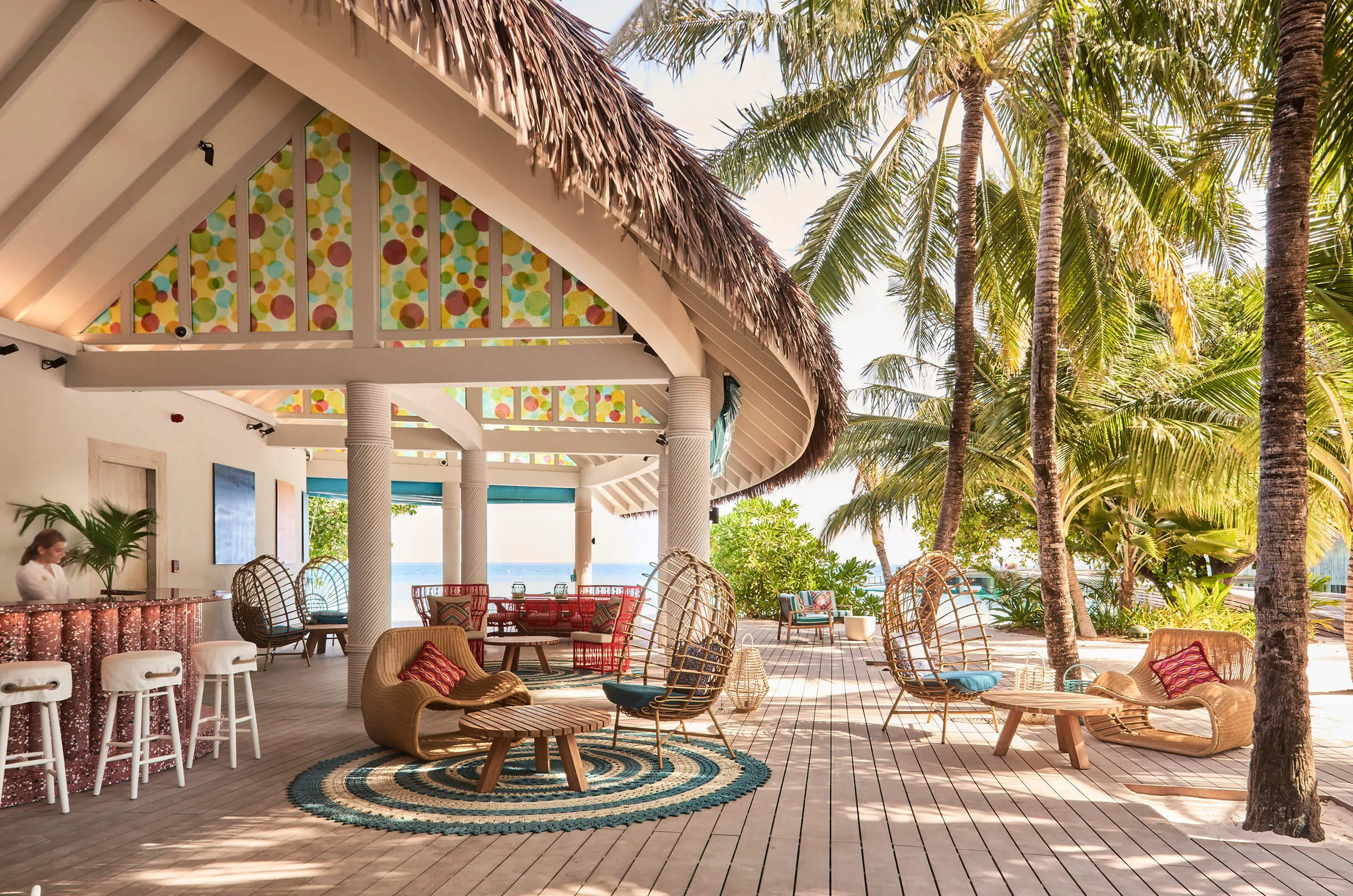 Open-sided lounge with colourful decor at Finolhu, Baa Atoll