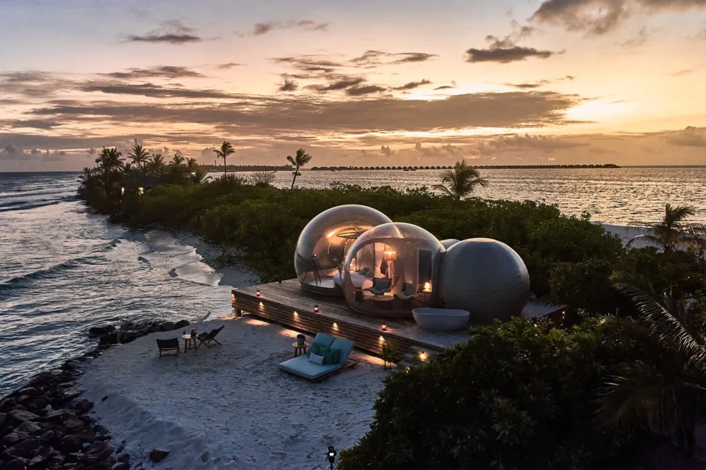 Bubble tents on the beach at sunset at Finolhu, Baa Atoll