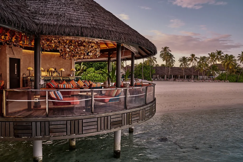 Thatched beach bar at sunset at Finolhu, Baa Atoll