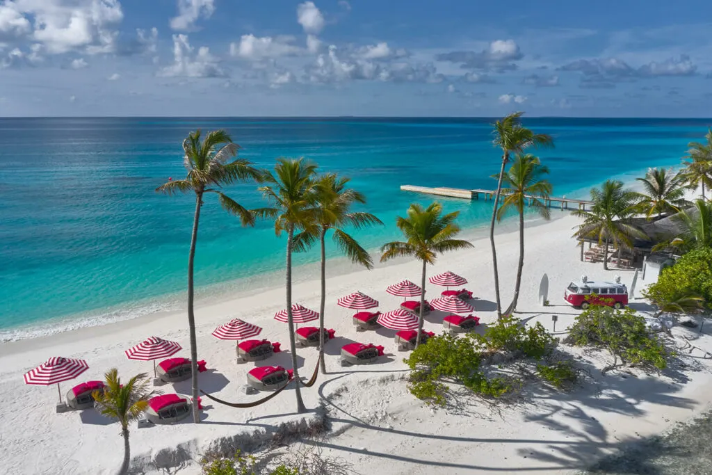 Beach with pink parasols at Finolhu, Baa Atoll