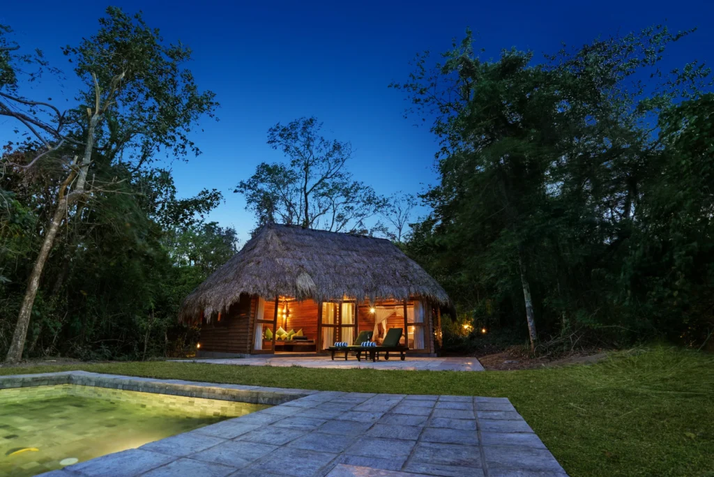 Lodge lit at dusk in the forest at Gal Oya Lodge