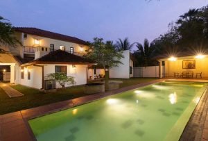 Villa and pool lit at dusk at Jetwing Mahesa Bhawan, Jaffna