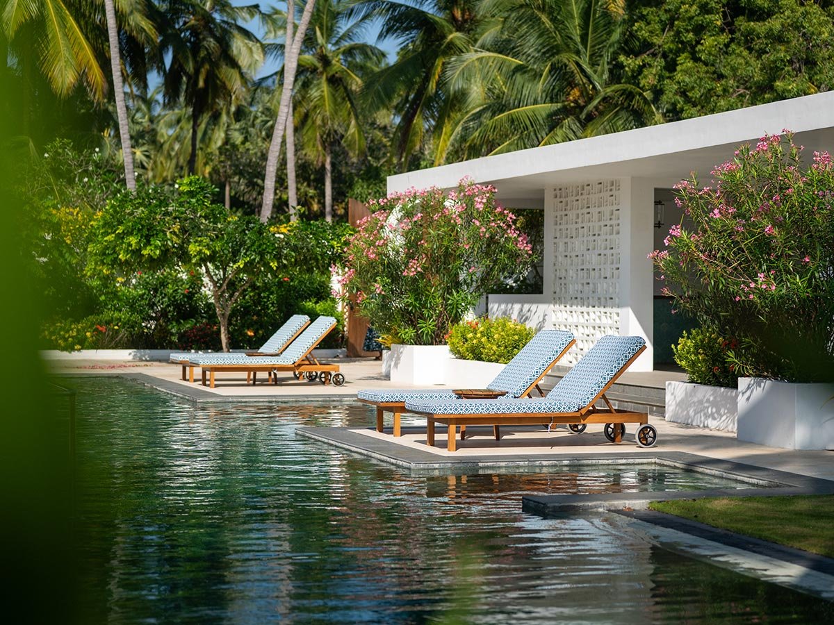 Pool and loungers beside the lagoon at Kalkudah Beach House