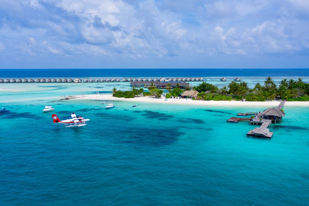 Seaplane beside the overwater villas at LUX South Ari Atoll