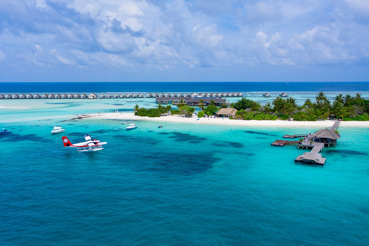 Seaplane beside the overwater villas at LUX South Ari Atoll