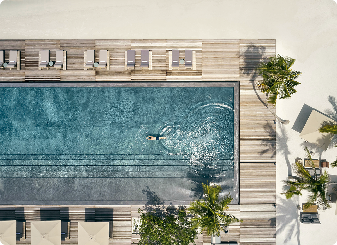 Swimmer in the long pool at Patina Maldives, Fari Islands