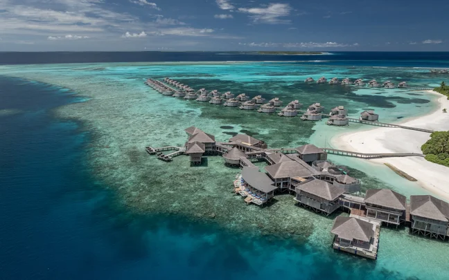 Aerial view of the island and overwater villas at Six Senses Laamu