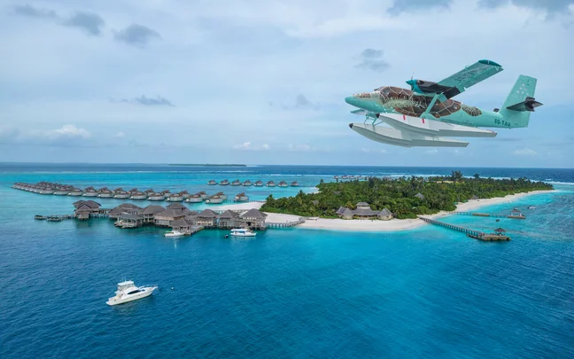 Seaplane flying over the island and villas at Six Senses Laamu