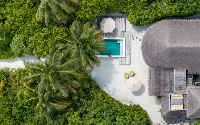 Aerial view of a beach villa and pool at Six Senses Laamu