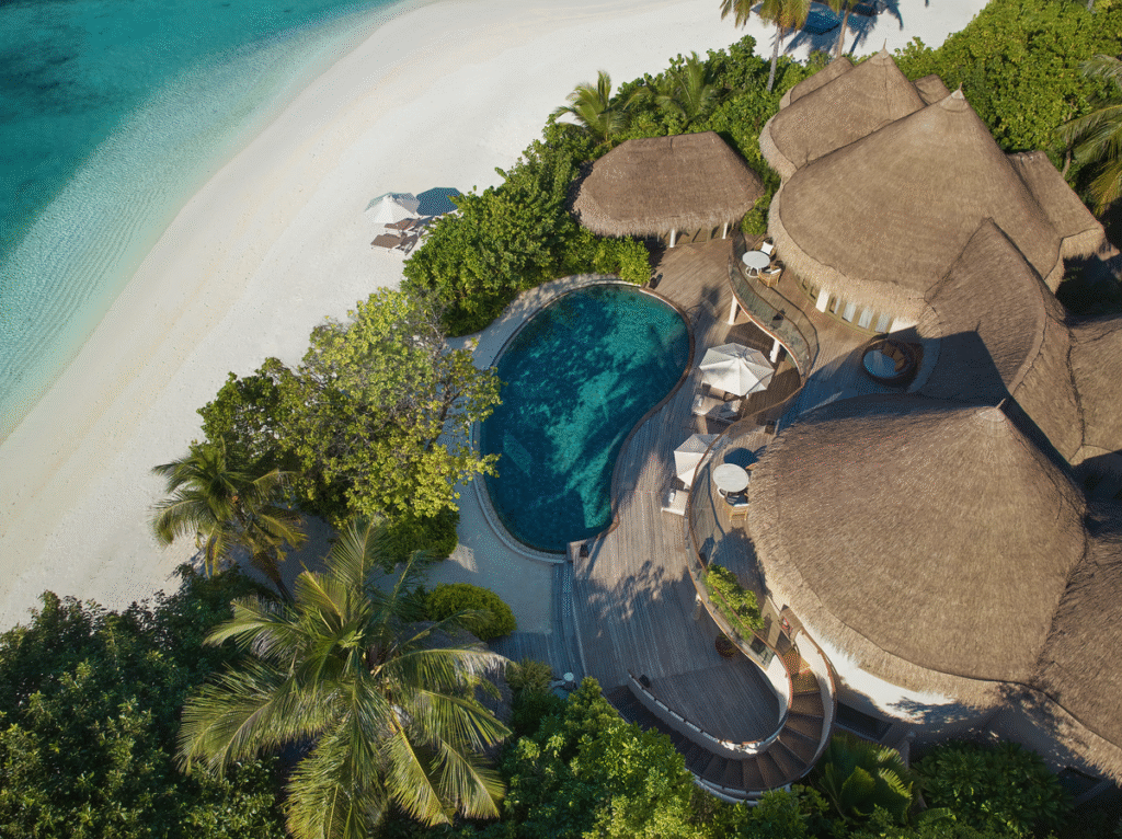 Aerial view of a beach house and pool at The Nautilus Maldives