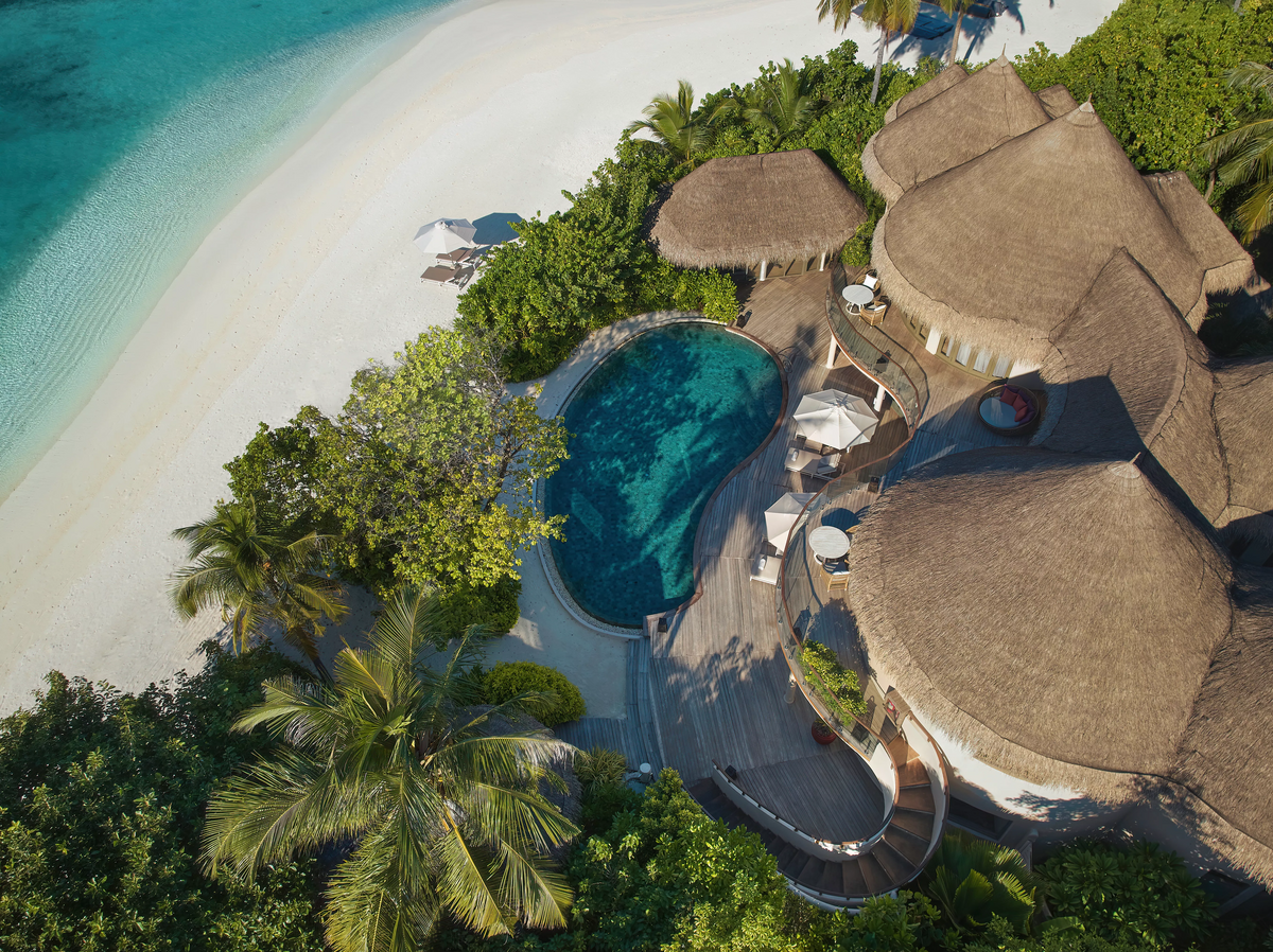 Aerial view of a beach house and pool at The Nautilus Maldives