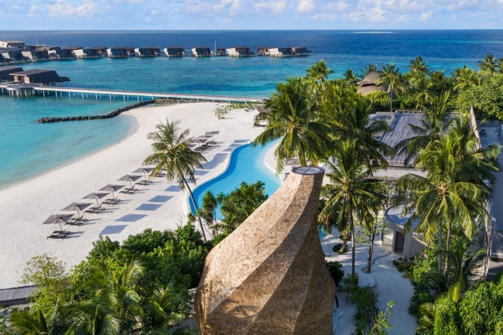 Resort pool and beach at The St. Regis Maldives Vommuli Resort