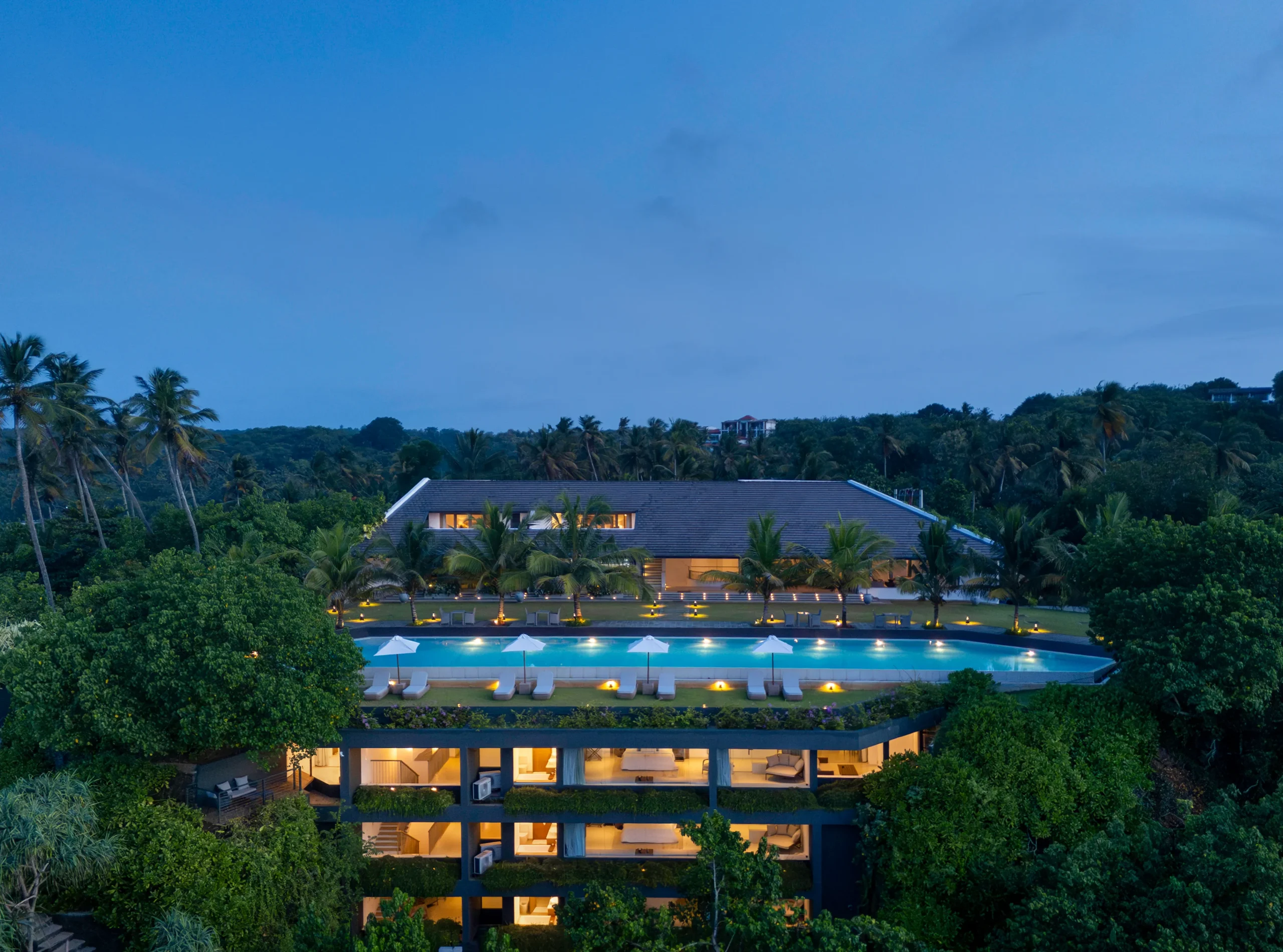 Resort and pool lit at dusk at Uga Prava, Tangalle