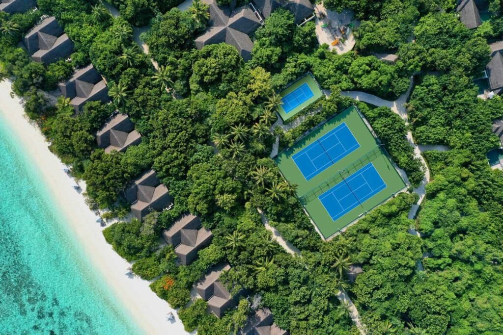 Aerial view of the tennis court and villas at Vakkaru Maldives