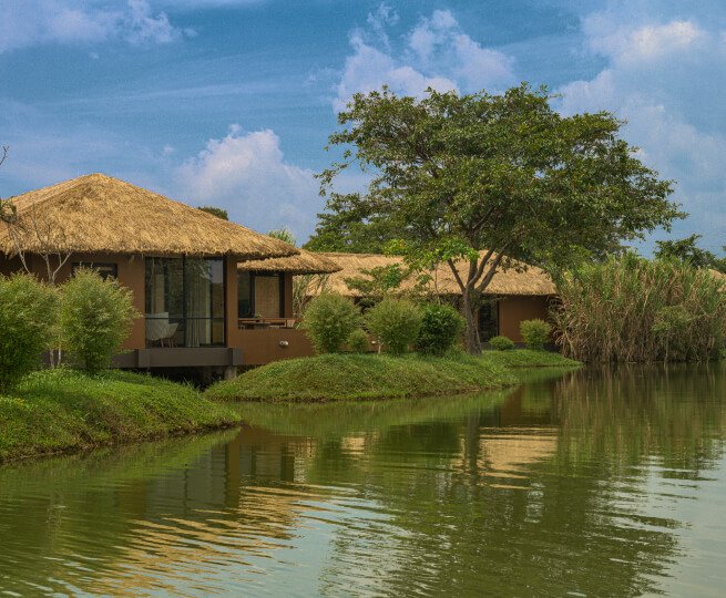Thatched villa at the water edge at Water Garden Sigiriya