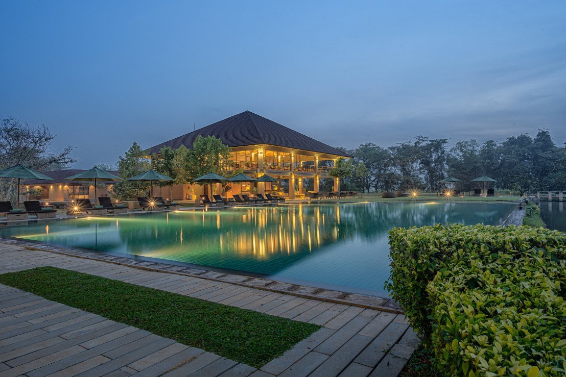 Resort and reflecting pool at dusk at Water Garden Sigiriya
